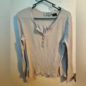 Long sleeve polyester shirt with a v neck that buttons up with clasps.